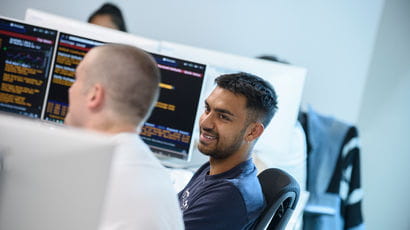 Students working on computers in a study room.