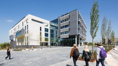 Students walking near a building on Frenchay Campus.