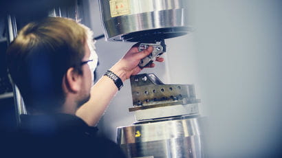 Person working on machinery. Person working on machinery.