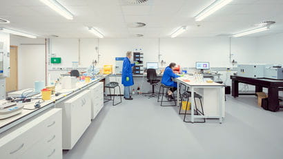 Two people working in a lab. Two people working in a lab.