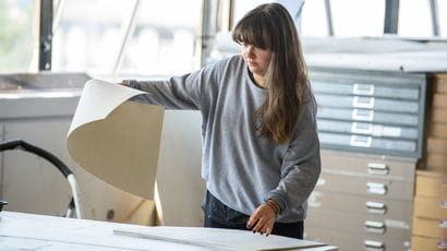 Person lifting a large sheet of paper. Person lifting a large sheet of paper.