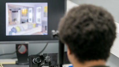 Person using a computer in a study room.