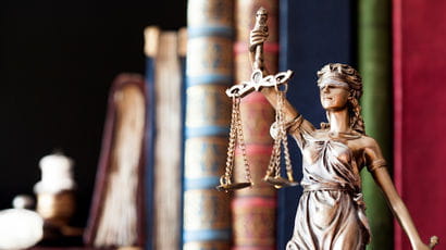 Statue of Lady Justice in a library.