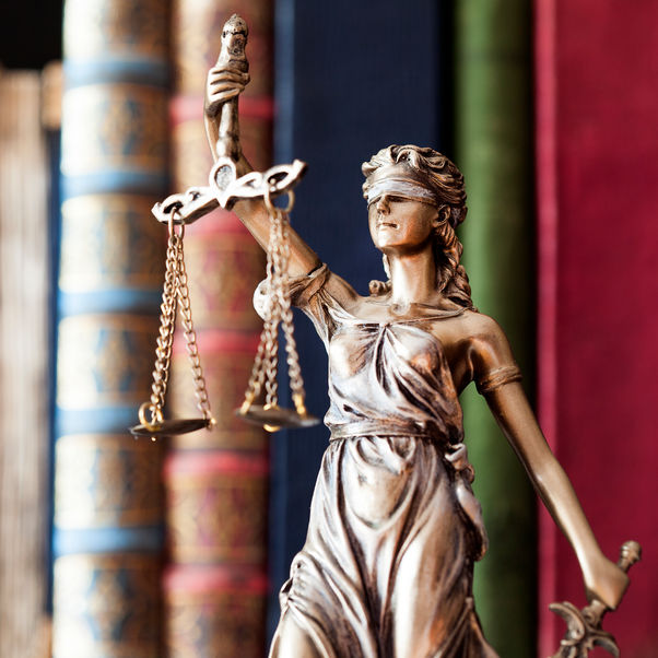 Statue of Lady Justice in a library.