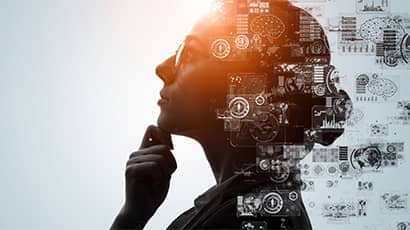 Profile of a bespectacled female doing deep thinking with graphics of computing, data, AI, business, concepts to the right side.