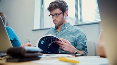 Researcher with book