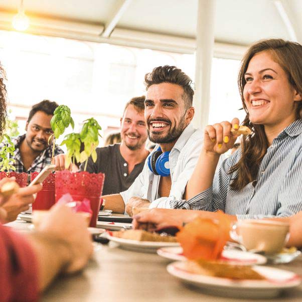 People smiling around a dinner table