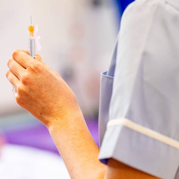 Nurse holding a syringe