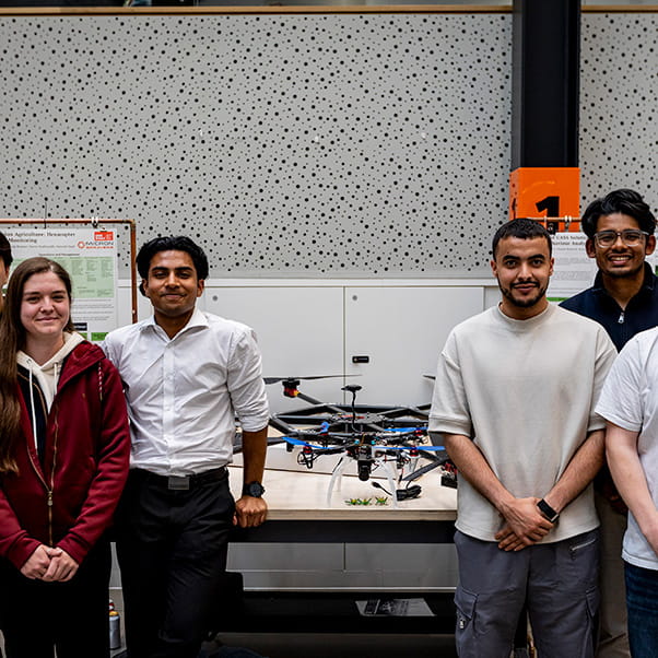 A group of students proudly displaying their drone prototype at the UWE Bristol degree show.