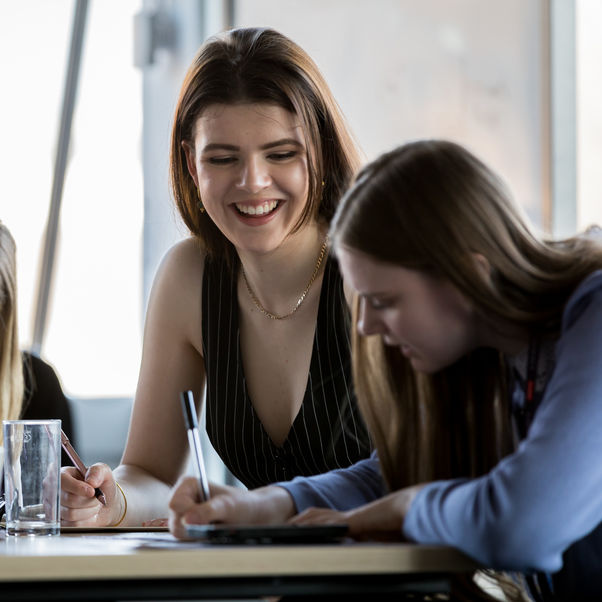 Two female students studying at a circular desk