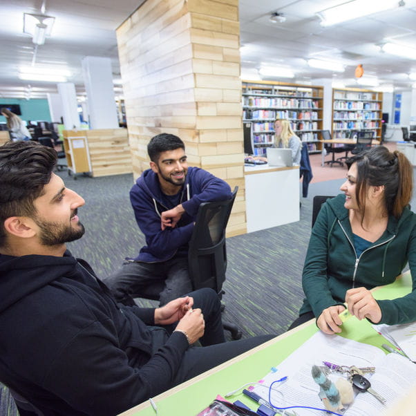 Three students in the library.