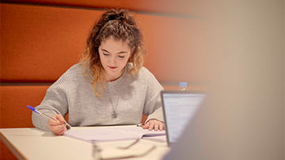 Student sitting in a booth studying