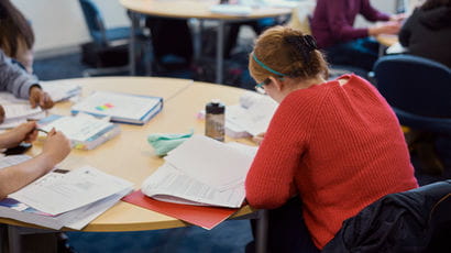 Student revising at a desk