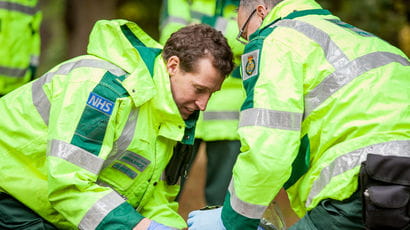 Two paramedic students treating a patient in a scenario