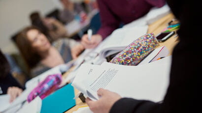 A group of students studying round a table.