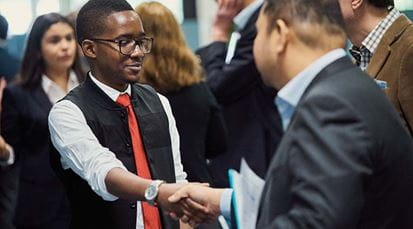 Student shaking hands with employer