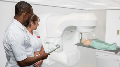 Students standing in front of medical equipment.