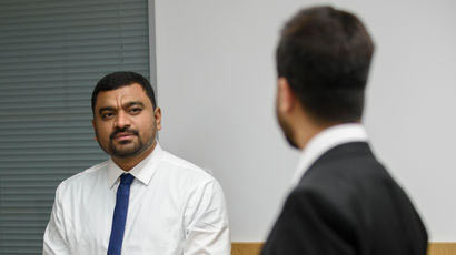 Two smartly dressed people having a conversation.