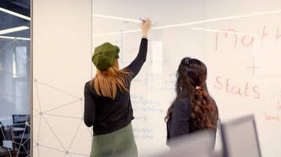 Two people in a maths teaching room.