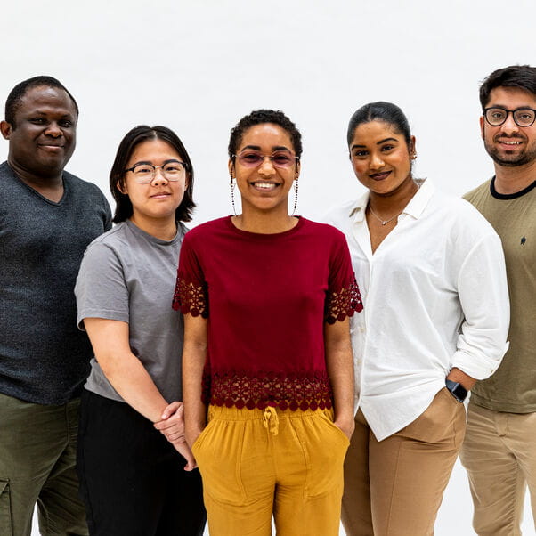 A group of global majority people smiling