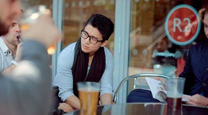 Student relaxing outside a campus cafe