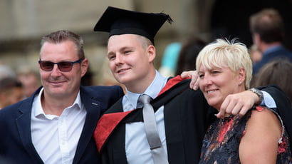 student and his family at graduation
