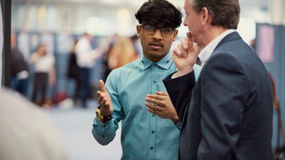 Student speaking with an employer at a fair