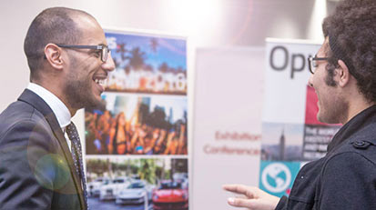 Two males having a conversation at an innovation fair