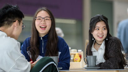 Group of students sitting in the Business School.