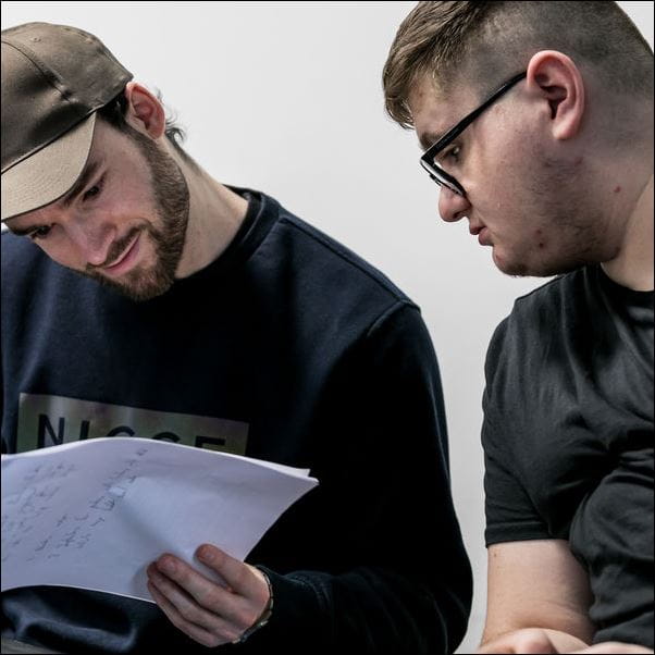 Two students looking at notes.