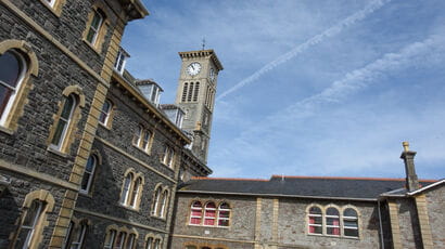 A large building featuring a prominent clocktower on the Glenside Campus.