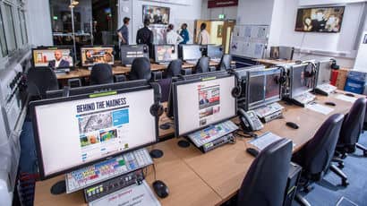 Computers in a computer lab with different software on their screens