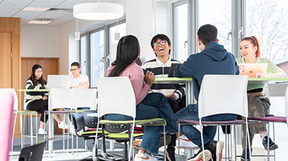 Group of students working and talking together in Glenside Library lounge