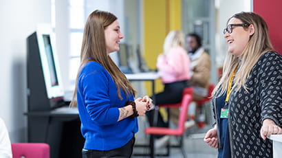 Library staff talking to a student in Glenside Library