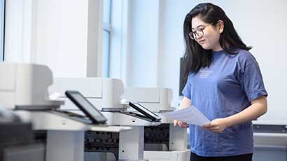 Student using printers in Frenchay Library.