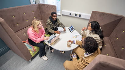 A group of students working in a study pod in the Glenside campus study lounge
