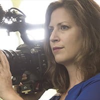 Photograph of Lindsey Paretti holding a film camera.