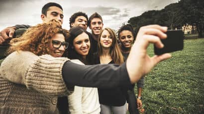 A group of students taking a selfie photo.