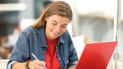 Smiling student on a laptop