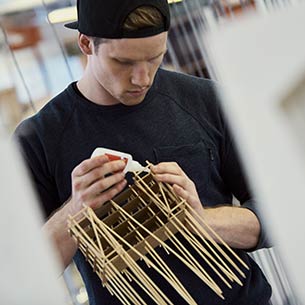 Architecture student working on a model.