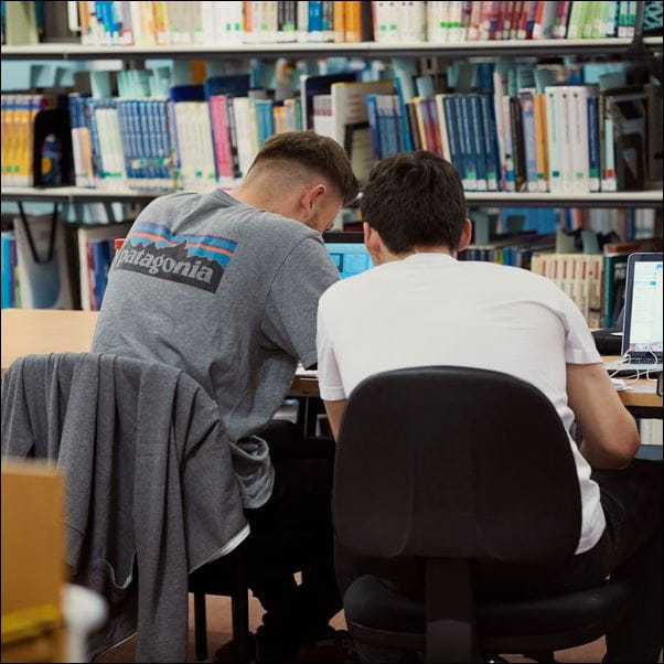 Students working at a table in the library.