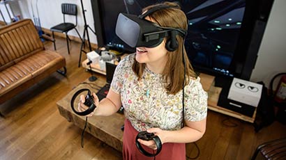 Person using a virtual reality (VR) headset in a room.