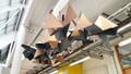 Student sculptures installed on the ceiling