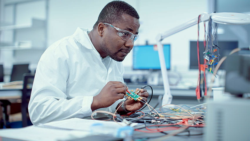 A student testing electronic circuit board