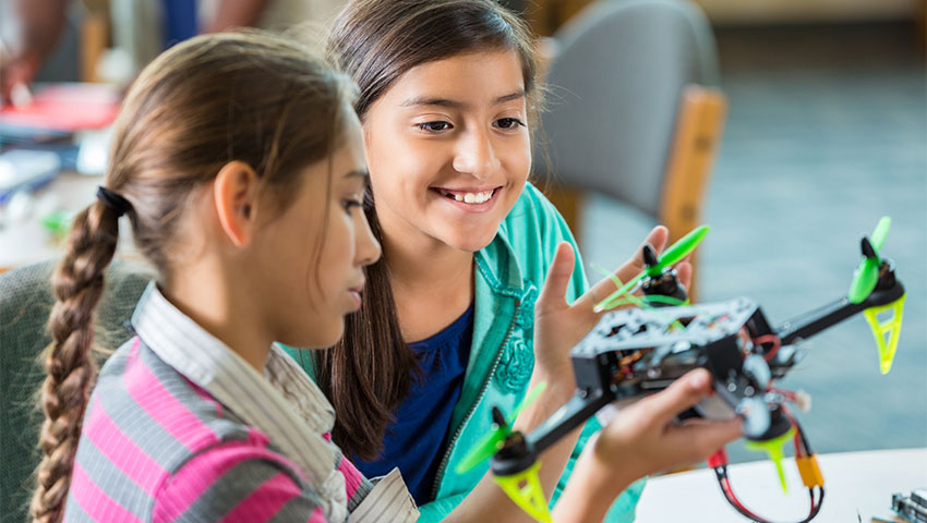 Two pupils playing with prototype drone