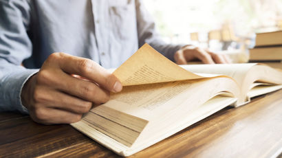 Hands turning the pages of a book