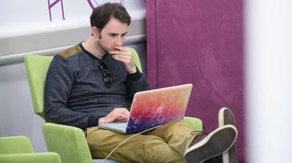 Student using a laptop in a study space.