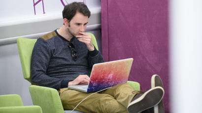 Student using a laptop in a study space.