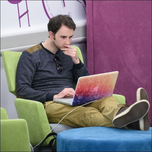 Student using his laptop in the library.