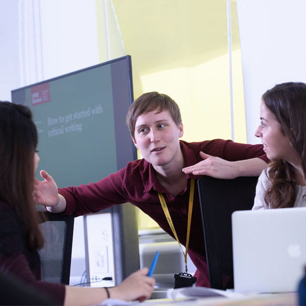 Students talking to a library staff member.